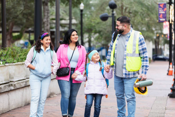 istock Hispanic parents walk children to school, on way to work 2178155890