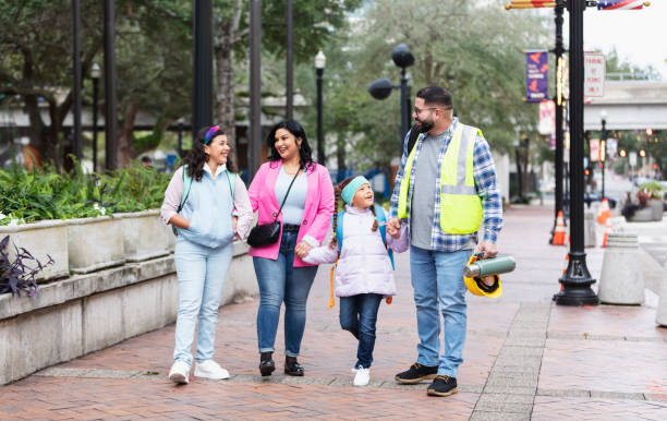 istock Hispanic parents walk children to school, on way to work 2178155893
