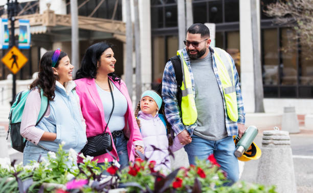 istock Hispanic parents walk children to school, on way to work 2178155894