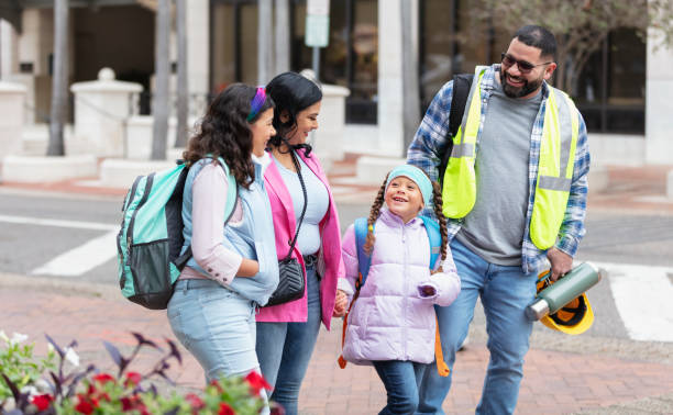 istock Hispanic parents walk children to school, on way to work 2178155898