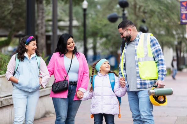 istock Hispanic parents walk children to school, on way to work 2178155901