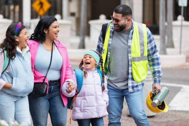 istock Hispanic parents walk children to school, on way to work 2178155975