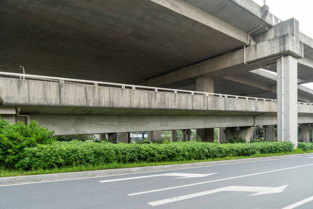 Concrete structure and asphalt road space under the overpass in the city