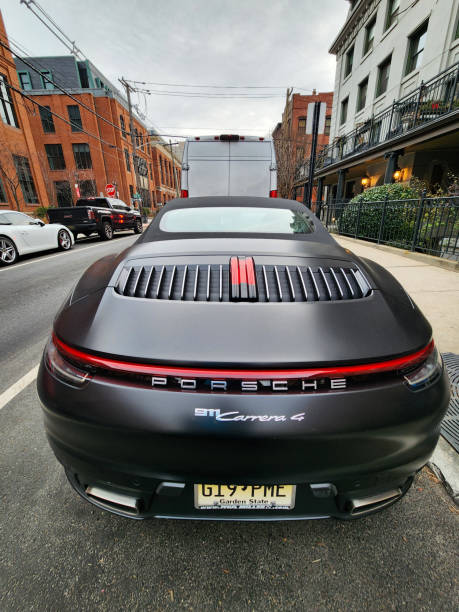 New York City, USA - February 10, 2024: Porsche 911 Carrera 4s cabriolet black car, rare view.