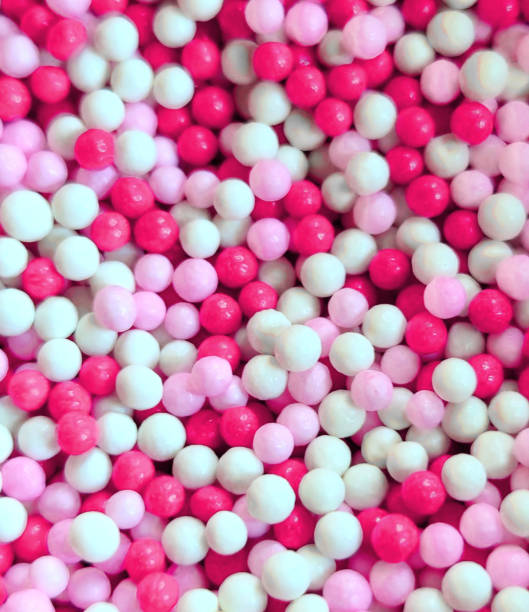 istock full frame pink white balls nonpareils candy fun party background 2178162739
