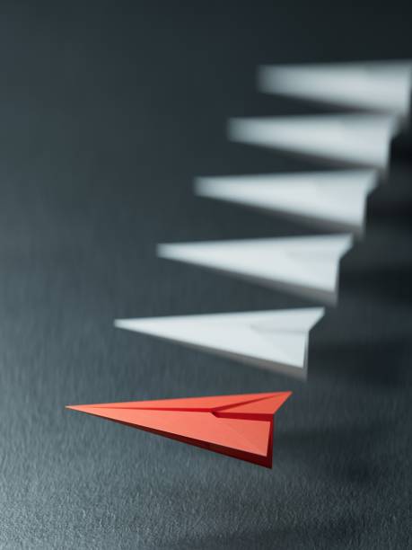 Different business concept.new ideas. paper art style. creative idea.Leaderplane concept using red paper plane among white planes.3D rendering on black background.