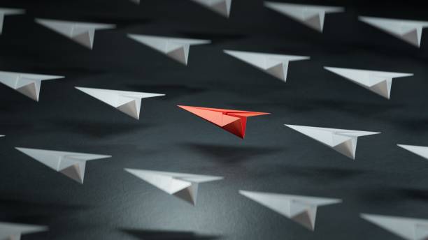 istock Different business concept.new ideas. paper art style. creative idea. red leader plane, standing out from the crowd of white planes.3D rendering on black background. 2178162907