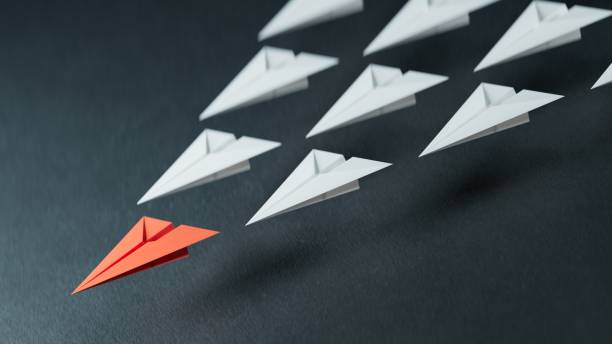 istock Leaderplane concept with red paper plane leading among white .3D rendering on black background. 2178163544