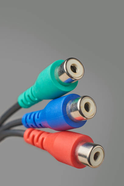 Digital audio and video technology concept. 3 colors RCA jacks or plugs on black background with copy space.