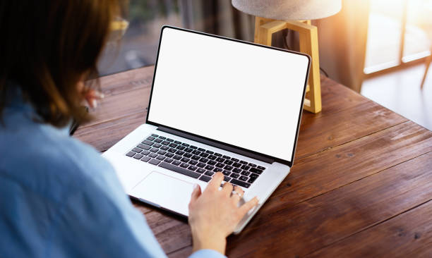 istock Mockup image of a woman using laptop with blank screen on wooden table 2178168149