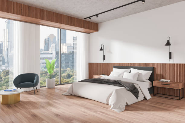 istock Stylish home bedroom interior with bed and armchair, panoramic window 2178169069