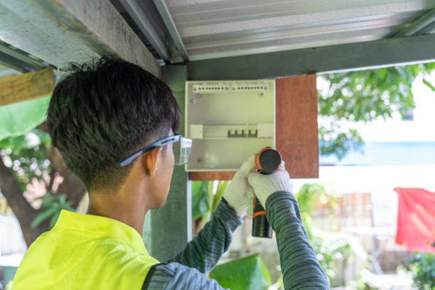 istock Male electrician installing electrical breaker box with cordless drill. 2178173741