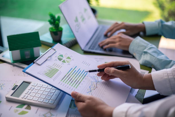 istock Analyzing green building performance metrics during business meeting. data analysis, green building, business meeting, sustainability, performance metrics, charts, graphs, real estate, eco-friendly. 2178174064