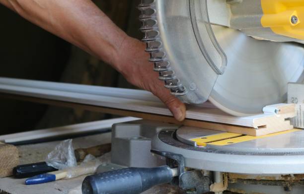 istock sawing off the end of the skirting board on a machine 2178174502