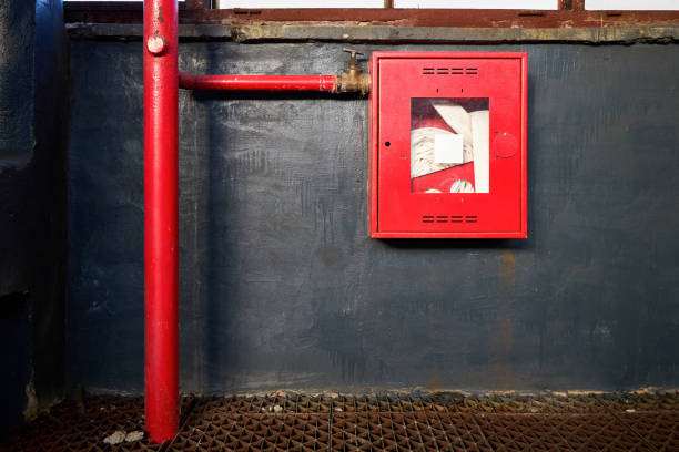 Red fire extinguisher at wall inside of condominium