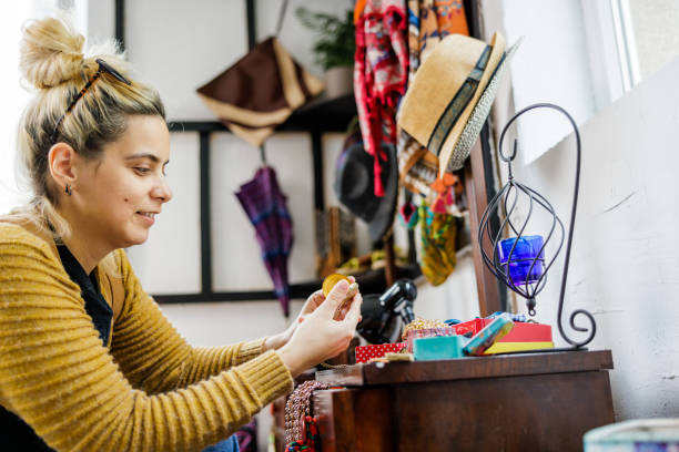 istock Woman choosing used goods in thrift store 2178175347