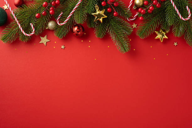 istock A vibrant red Christmas background featuring pine branches, candy canes, and golden stars, evoking holiday cheer and festive spirit 2178175910
