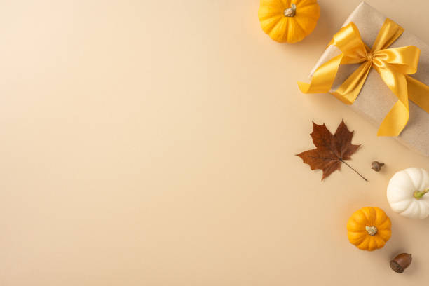 istock Festive Thanksgiving composition featuring a wrapped gift with pumpkins and autumn leaves. Perfect for seasonal celebrations and autumnal themes 2178175929