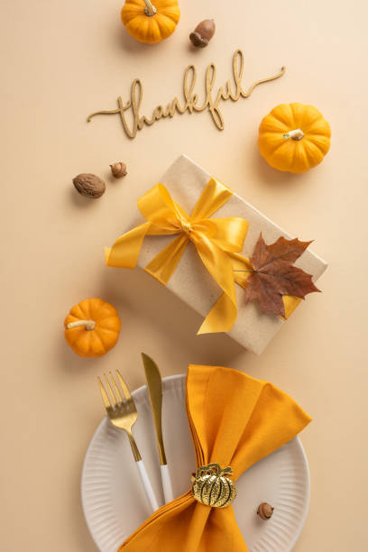 istock Thanksgiving vertical table setting featuring pumpkins, a wrapped gift with ribbon, and a festive tableware arrangement conveying gratitude and autumn vibes 2178175940