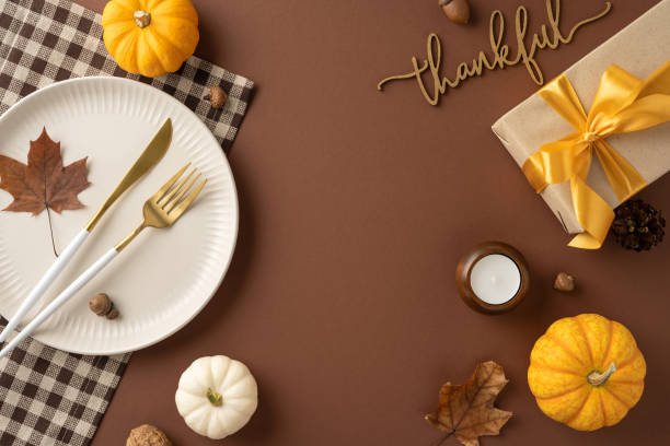 istock Elegant Thanksgiving table setup featuring pumpkins, leaves, and a wrapped gift, creating a warm autumn atmosphere perfect for celebrations 2178175954