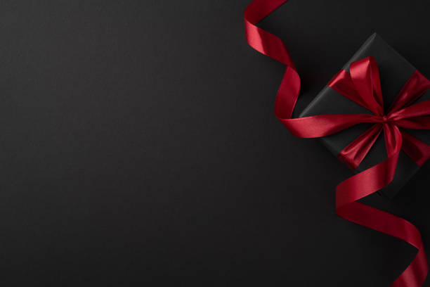 istock A luxurious black gift box wrapped with a vibrant red ribbon, ideal for Black Friday or festive occasions, symbolizing elegance and celebration 2178175969