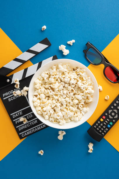 istock A vertical bowl of popcorn with a clapperboard, 3D glasses, and remote control, symbolizing a cozy movie night 2178175995