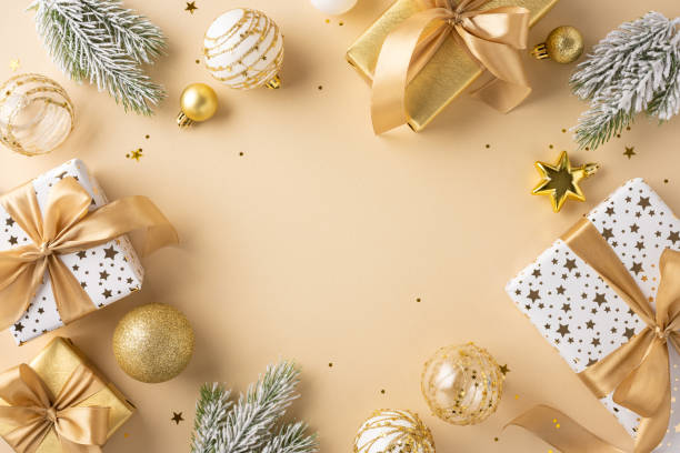 istock Stylish Christmas presents wrapped in gold and white with festive decorations, including ornaments and pine branches, creating a luxurious holiday atmosphere 2178175997
