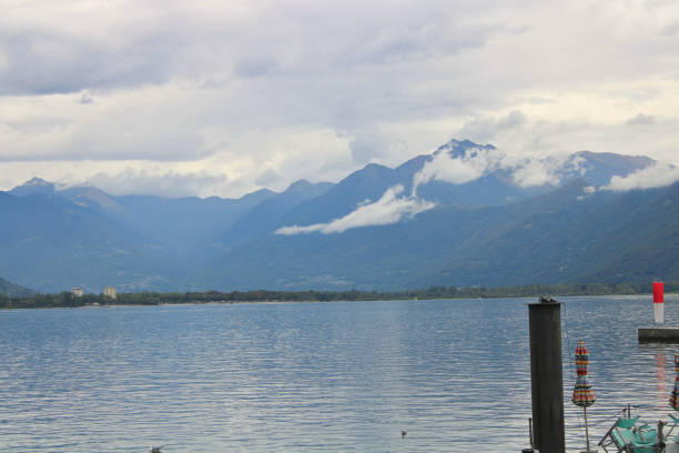 clouds over the mountains of Lake Maggiore on the Swiss side of Locarno during a cloudy summer day