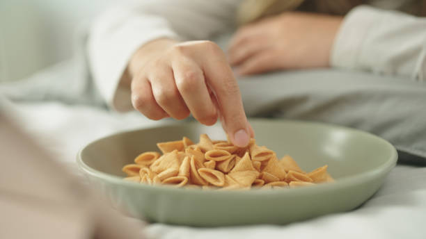 Woman relax watching movie while eating snacks.