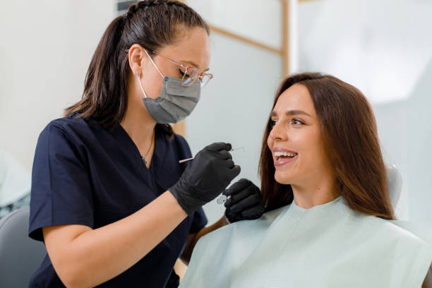 istock Dentist examines patient in modern dental office during routine check-up 2178177107