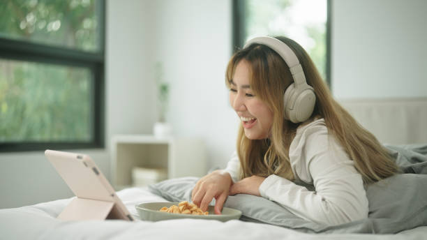 istock Woman relax watching movie while eating snacks. 2178177166