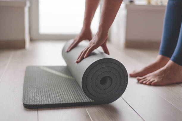 istock Yoga woman folding roll mat before after meditation practice training at home closeup 2178179401