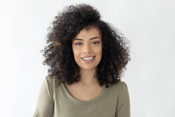 istock Beautiful curly haired woman looking at camera 2178179501