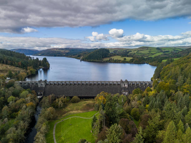 istock Dam holding back water reservoir surrounded by forest 2178182209