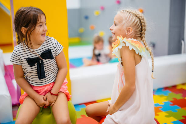 istock Two Girls Bouncing On Hopper Balls In Kid's Playroom 2178192202