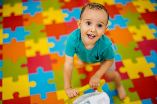 Young boy playing in kid's playroom.