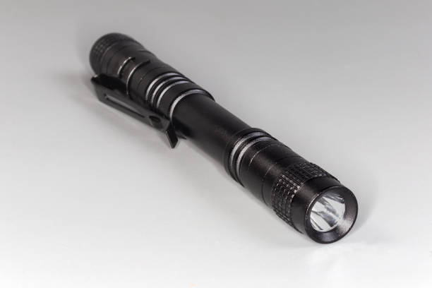 istock Pocket tactical electric LED mini flashlight on a gray background 2178194626