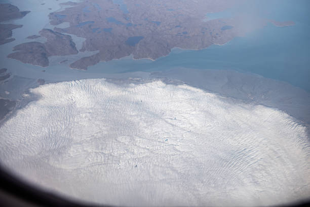 View down to a glacier during inflight over the rocky coast outside Illulissat