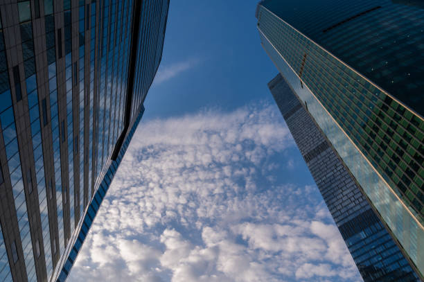 Angled view of modern skyscrapers in business district against blue sky. Looking Up  high-rise office buildings.