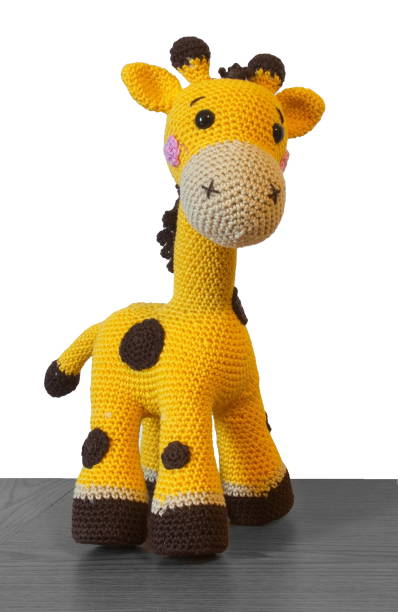Crochet toys and yarn arranged with wooden blocks and ladder create a cozy, creative childhood-inspired scene.