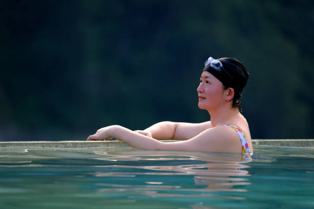 An Asian woman in a swimming pool