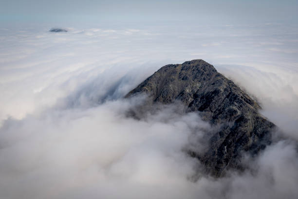 Another from a remarkable morning on Bla Bheinn on the Isle of Skye.  \nGarbh Bheinn emerges like a rocky island from a turbulent sea of cloud, whilst in the distance the summit of Glamaig has the appearance of a breaching whale emerging from the surf.\nDays in the mountains don't get much better than this.