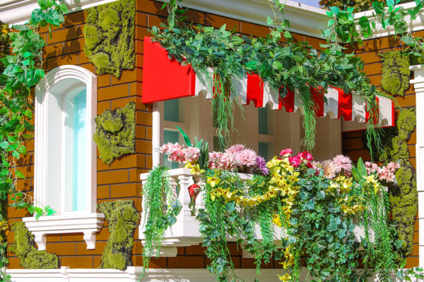 Colorful red flowers on the wooden terrace in Venice, Italy