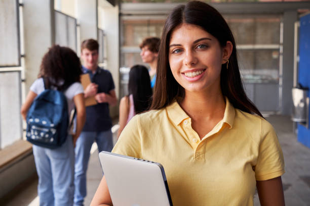 istock Happy portrait of a female high school student looking at camera smiling after class. 2178201204