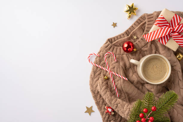 istock Warm and inviting winter setup featuring a sweater, coffee mug, candy canes, and festive decorations conveying a holiday atmosphere 2178202437
