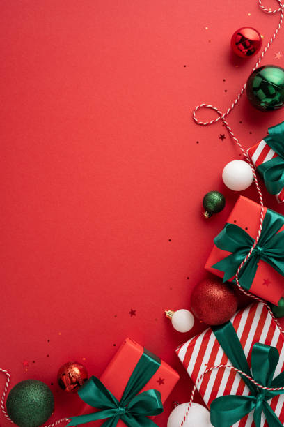 istock Stylish vertical Christmas presents with green bows and festive decorations on a red surface create a cheerful holiday atmosphere 2178202499