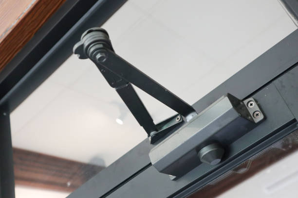 istock door closer. open closer on a glass door in the interior, a device for controlling the process of damping closing and opening, 2178205002