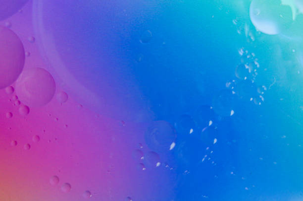 istock Macro view of oil droplets clinging together, hovering above water with a light gradient, ideal for a clean and elegant wallpaper 2178206539