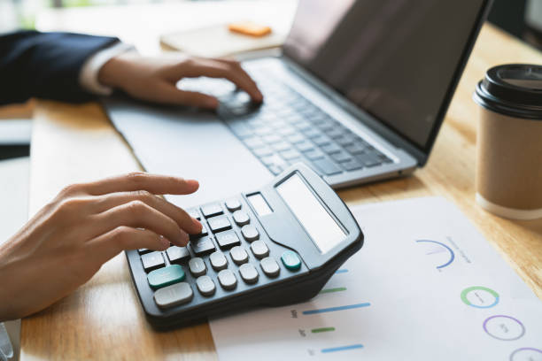 istock Accountant using calculator with financial documents on desk office. 2178211561