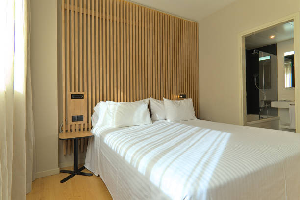 istock Bright Hotel Room with Wooden Decor and Direct Bathroom View 2178212381